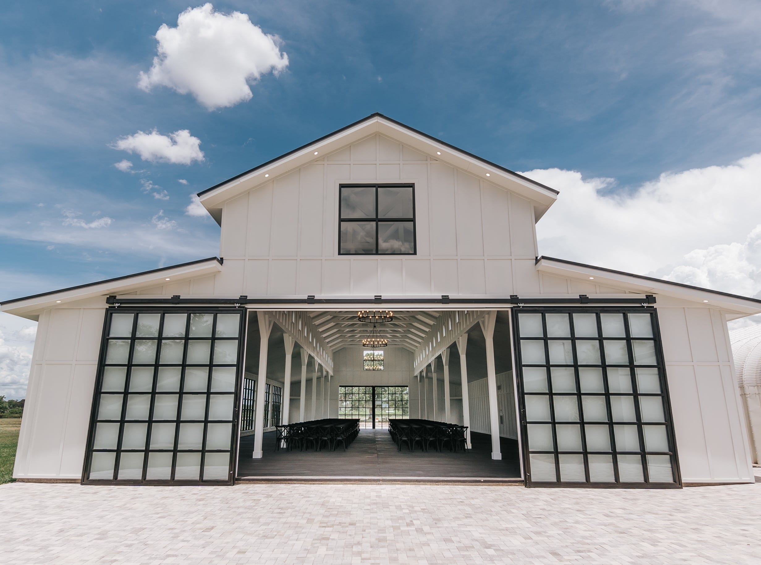 Modern Florida Wedding venue featuring an elegant white glass barn.
