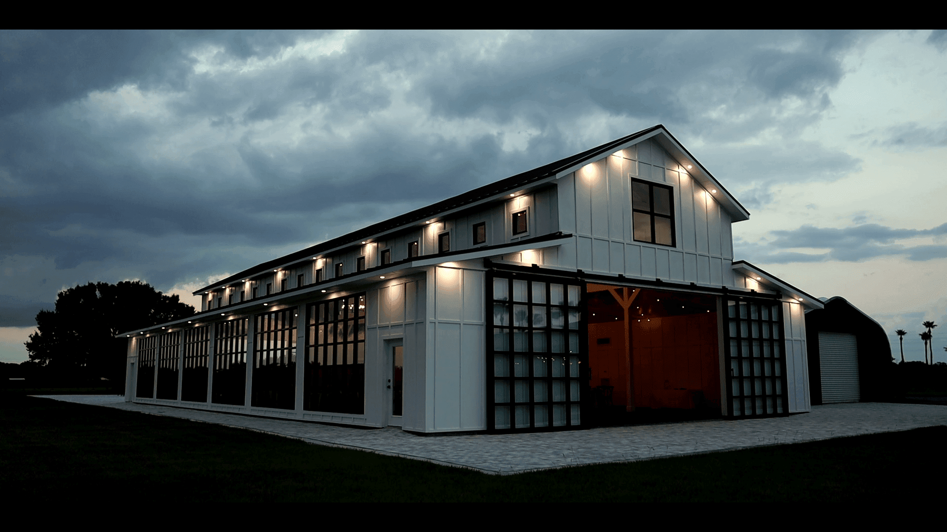 A Florida Wedding barn is lit up at dusk at a stunning Florida Wedding venue.