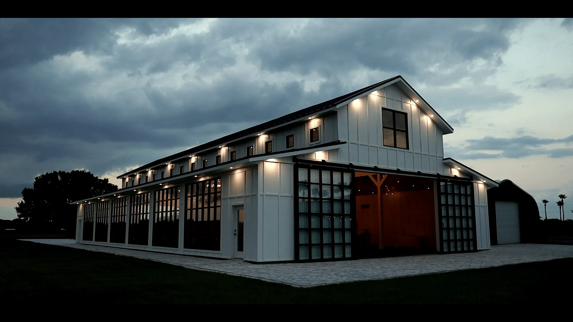 A Florida Wedding barn is lit up at dusk at a stunning Florida Wedding venue.